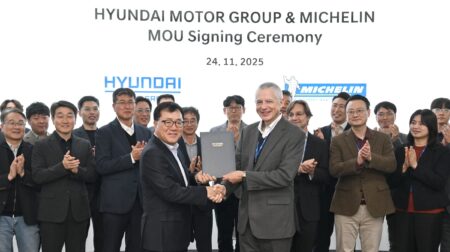 (In the middle, from left) Yongsuk Shin, Vice President and Head of Genesis Engineering Design Center at Hyundai Motor Group, and Georges Levy, Executive Vice President and Head of Asia Pacific Automotive Original Equipment at Michelin, with other participants standing in the background during the MOU signing ceremony.